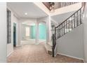 Open foyer featuring tile flooring, staircase, and arched doorways leading to other rooms at 11724 N 148Th Ave, Surprise, AZ 85379