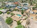 Large desert property with pool, cabana, mature trees, and a circular driveway in a residential neighborhood at 12212 N 66Th St, Scottsdale, AZ 85254
