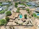 Spacious desert property features pool, cabana, circular driveway, mature trees, and fenced backyard at 12212 N 66Th St, Scottsdale, AZ 85254
