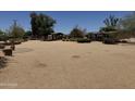 Expansive backyard area with desert landscaping, covered patio, and ample space for outdoor activities at 12212 N 66Th St, Scottsdale, AZ 85254