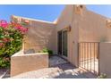 Charming courtyard patio with desert landscaping, privacy wall, seating, and gated access to the home at 13041 S 45Th Pl, Phoenix, AZ 85044