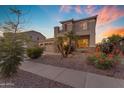 Attractive home featuring a balcony, desert landscaping, a three-car garage and well-kept surroundings at 13824 W Gelding Dr, Surprise, AZ 85379
