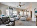 Bright living room featuring neutral furniture, shuttered windows, and a ceiling fan at 14300 W Bell Rd # 312, Surprise, AZ 85374