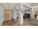 Inviting foyer with tile flooring, natural light, and a view of the dining area, perfect for welcoming guests at 14517 W Cortez St, Surprise, AZ 85379