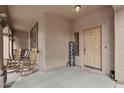 Charming covered front porch with rocking chairs and a 'Welcome' sign, creating a warm and inviting entryway at 14517 W Cortez St, Surprise, AZ 85379