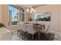 Dining area with a dining table and view from a large window at 15032 N 54Th Pl, Scottsdale, AZ 85254
