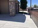 Inviting side yard featuring desert landscaping, custom gate, and stone columns at 15625 N Jerry St, Surprise, AZ 85378