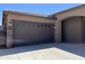 A spacious two-car garage, conveniently attached with an oversized driveway and traditional doors at 15625 N Jerry St, Surprise, AZ 85378