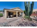 Covered back patio area with plenty of space for seating and a desert landscape at 17317 N Ponca Way, Surprise, AZ 85374