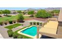 Aerial view of backyard showing desert landscaping, refreshing pool and raised deck at 1932 S 220Th Dr, Buckeye, AZ 85326