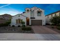 Beautiful two-story home with a brick driveway, lovely landscaping, and a welcoming front entrance at 21194 W Hillcrest Blvd, Buckeye, AZ 85396