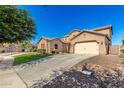 Side view of a two-story home, showcasing its spacious driveway and well-maintained landscaping at 21605 S 187Th Way, Queen Creek, AZ 85142