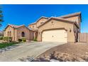 A two-car garage attached to the home, with a driveway and low maintenance front yard at 21605 S 187Th Way, Queen Creek, AZ 85142