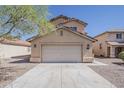 Home exterior featuring a two-car garage, neutral colors, and low maintenance landscaping at 22328 W Woodlands Ave, Buckeye, AZ 85326