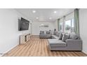 Bright living room with modern flooring, neutral walls, and a comfortable gray sectional couch at 2425 W Shady Glen Ave, Phoenix, AZ 85023