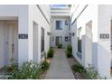 Exterior view of a well-maintained apartment complex with easy-access walkways and colorful landscaping at 295 N Rural Rd # 143, Chandler, AZ 85226