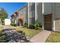 Full exterior view of a townhome with a grassy area and a sidewalk in front at 3116 W Royal Palm Rd, Phoenix, AZ 85051