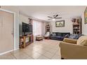 Cozy living room with tile floors, ceiling fan, couches, and natural lighting at 3116 W Royal Palm Rd, Phoenix, AZ 85051