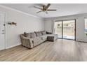A bright living room featuring a comfortable sectional sofa and sliding glass doors to the outside at 3500 N Hayden Rd # 203, Scottsdale, AZ 85251