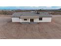 A single story home with a covered back patio and large windows for natural light at 35672 W Chipman Rd, Tonopah, AZ 85354