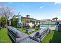 The backyard is designed for relaxing with modern outdoor furniture and pool in the background at 4415 S Poplar St, Tempe, AZ 85282