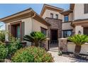 Inviting front entrance with lush landscaping and a secure gated brick-paved walkway at 4463 S Oregon Ct, Chandler, AZ 85248