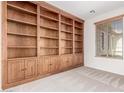 Charming office space with a built-in bookcase and a window providing natural light at 4520 N 151St Dr, Goodyear, AZ 85395
