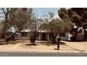 Charming single-story home with a well-maintained front yard and mature trees at 461 N Cheri Lynn Dr, Chandler, AZ 85225