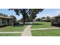Well-manicured community lawn with trees and walkways in a well-maintained neighborhood at 6029 N 31St Ave, Phoenix, AZ 85017