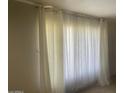 Bright living room featuring large window with light filtering curtains at 6029 N 31St Ave, Phoenix, AZ 85017