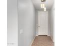 Clean entryway with tiled floor, pendant lights and white door at 6300 S Nash Way, Chandler, AZ 85249