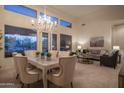Open-concept living and dining area with chandelier and lots of light at 6481 E Amber Sun Dr, Scottsdale, AZ 85266