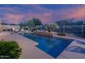 Beautiful pool with water feature and desert landscaping at 6481 E Amber Sun Dr, Scottsdale, AZ 85266