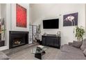 Open living room featuring high ceilings, fireplace and large-screen tv at 6531 N 10Th Pl, Phoenix, AZ 85014