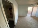 Bright bedroom with carpet, ensuite bathroom and sliding door to exterior deck at 6911 W Devonshire Ave # 1269, Phoenix, AZ 85033