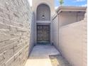 Arched entry way leads to the front door, with flagstone pavers and desert landscaping at 7770 E Camelback Rd # 23, Scottsdale, AZ 85251