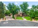 Beautiful home featuring manicured landscaping, a brick driveway and accents, and mature trees providing natural shade at 8219 S Pecan Grove Cir, Tempe, AZ 85284