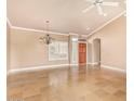 Large living room featuring tiled floors, plantation shutters, and a decorative chandelier at 8402 W Rosemonte Dr, Peoria, AZ 85382