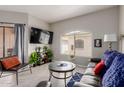 Inviting living room with modern decor, a flat-screen TV, and sliding glass doors at 10030 W Indian School Rd # 215, Phoenix, AZ 85037