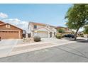 Desirable two-story home with a well-manicured front yard and a two-car garage in a quiet suburban neighborhood at 11158 N 162Nd Dr, Surprise, AZ 85379