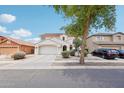 Lovely two-story home with a well-manicured front yard and a spacious driveway leading to a two-car garage at 11158 N 162Nd Dr, Surprise, AZ 85379