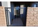 Metal gate and brick fencing at the entry way to the home at 120 W Milada Dr, Phoenix, AZ 85041