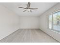 Bright bedroom with neutral carpet, light-colored walls, ceiling fan, and a window offering natural light at 12201 N 22Nd Pl, Phoenix, AZ 85022