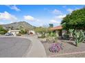 Well-maintained single-story home with desert landscaping, a tile roof, and mountain views in a desirable location at 13019 N 23Rd Pl, Phoenix, AZ 85022