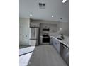Modern kitchen with stainless steel appliances and sleek gray cabinetry at 14860 S Capistrano Rd, Arizona City, AZ 85123