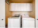 Convenient laundry area equipped with modern washer and dryer and cabinets at 1500 N Markdale -- # 68, Mesa, AZ 85201