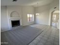 Spacious living room featuring a fireplace and tile flooring at 15801 W Meade Ln, Goodyear, AZ 85338