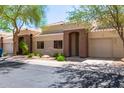 Charming single-story home boasts lush landscaping, a private garage, and a welcoming entrance at 16450 E Avenue Of The Fountain Ave # 11, Fountain Hills, AZ 85268