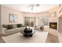 Cozy living room featuring a fireplace, plush seating, and large windows with natural light at 16450 E Avenue Of The Fountain Ave # 11, Fountain Hills, AZ 85268