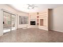 Bright living room features tiled floors, recessed shelving, and a cozy stone fireplace at 16450 E Avenue Of The Fountain Ave # 11, Fountain Hills, AZ 85268